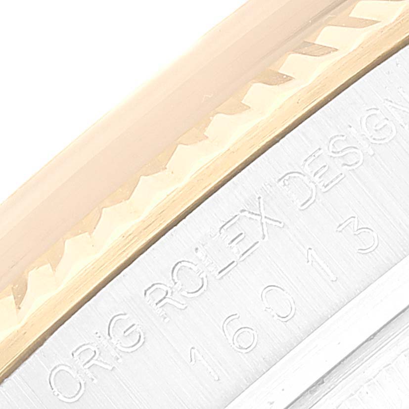 The image shows a close-up of the side of a Rolex Vintage Collection 16013 Men's Steel and Gold (two tone) Champagne Dial 16013 Men's Steel and Gold (two tone) Champagne Dial model, highlighting the fluted bezel and engraved text.