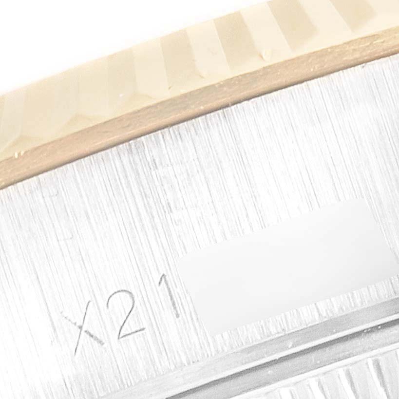 The image shows a close-up view of the fluted bezel and part of the case of a Rolex Datejust 69173 Women's Steel and Gold (two tone) Champagne Dial 69173 Women's Steel and Gold (two tone) Champagne Dial watch, with a partial serial number visible.