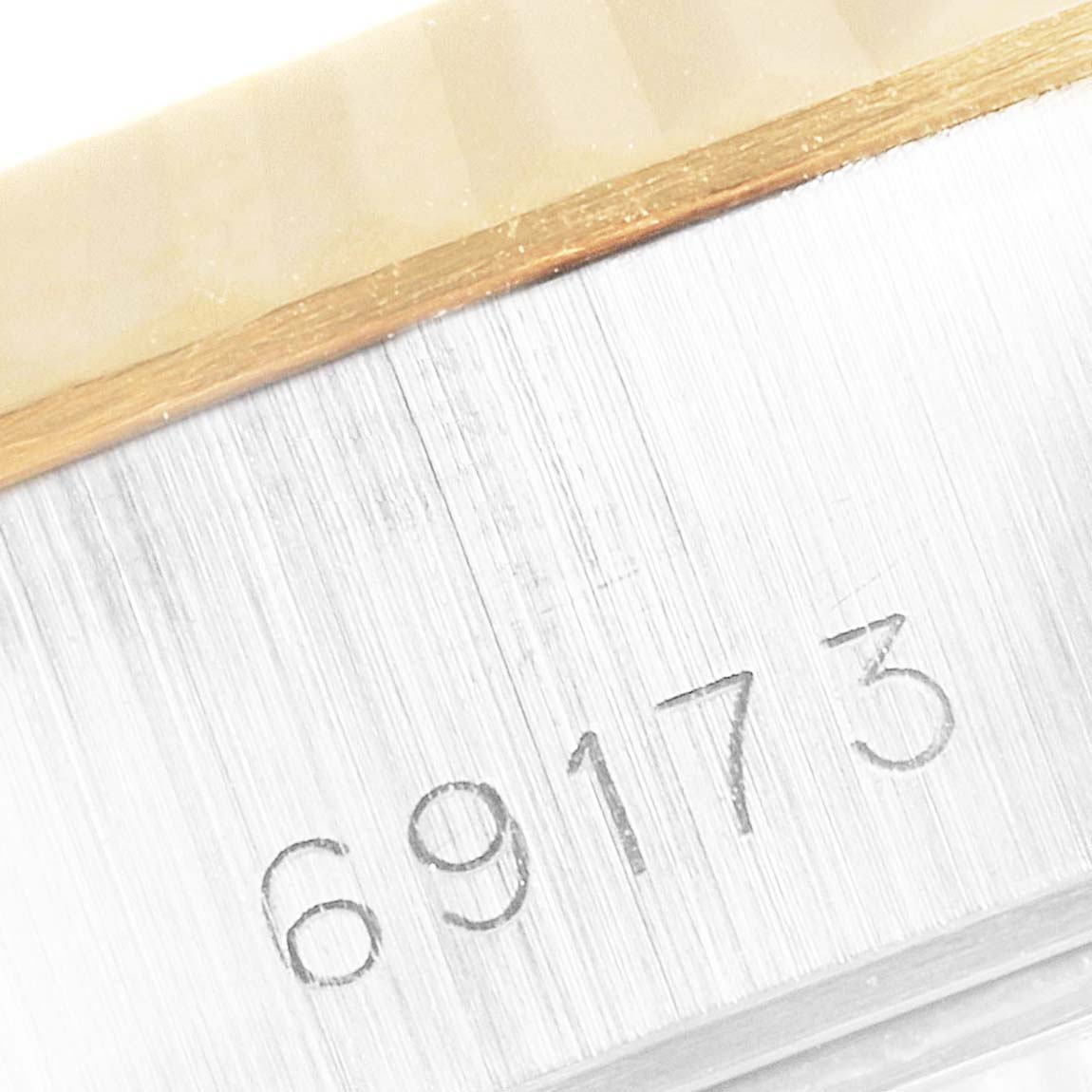 This close-up image shows the serial number engraving on the case side of a Rolex Datejust 69173 Women's Steel and Gold (two tone) Champagne Dial 69173 Women's Steel and Gold (two tone) Champagne Dial watch.