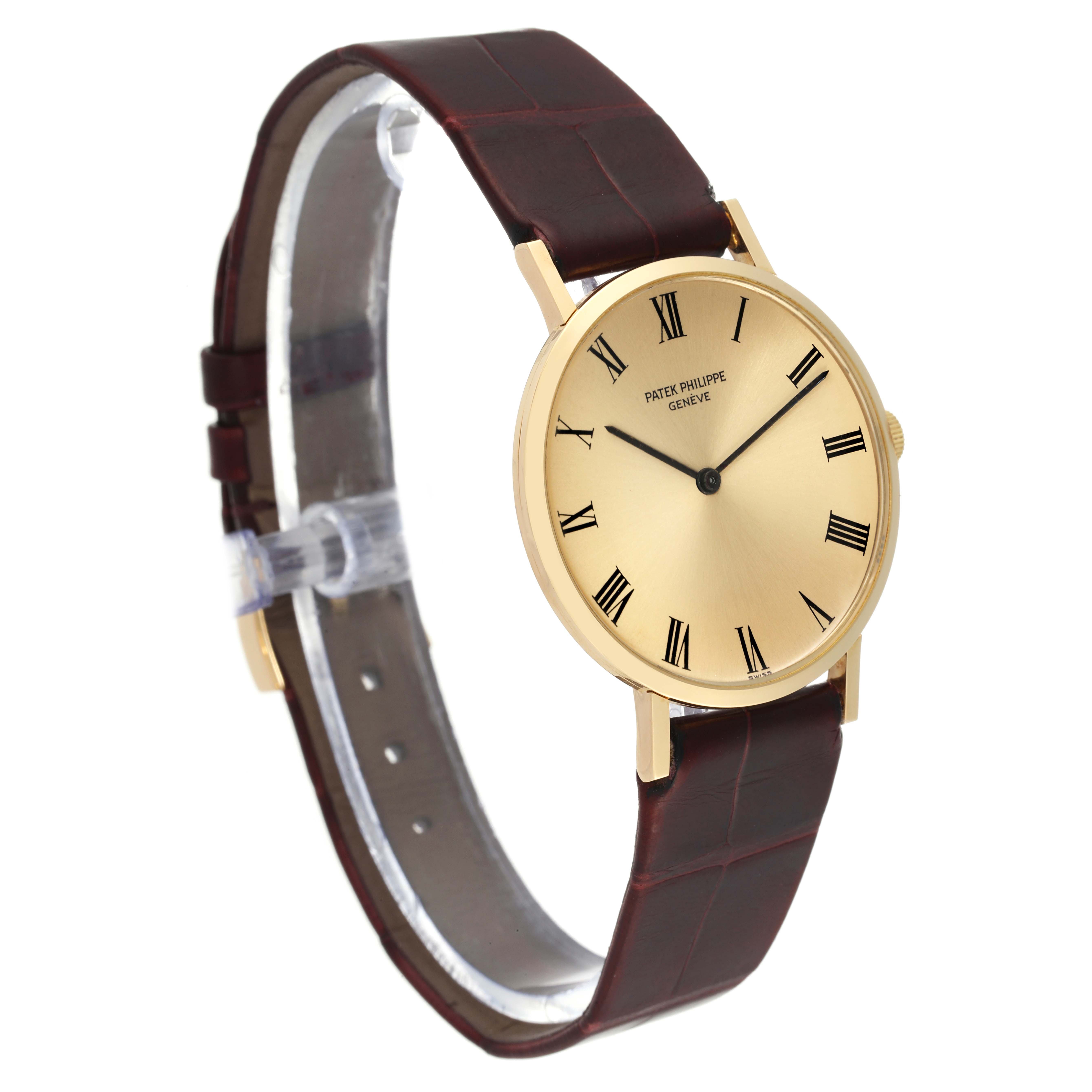 The image shows a Patek Philippe Calatrava 3537 Men's Yellow Gold Champagne Dial 3537 Men's Yellow Gold Champagne Dial watch at an angle, highlighting its round dial, gold case, and brown leather strap.