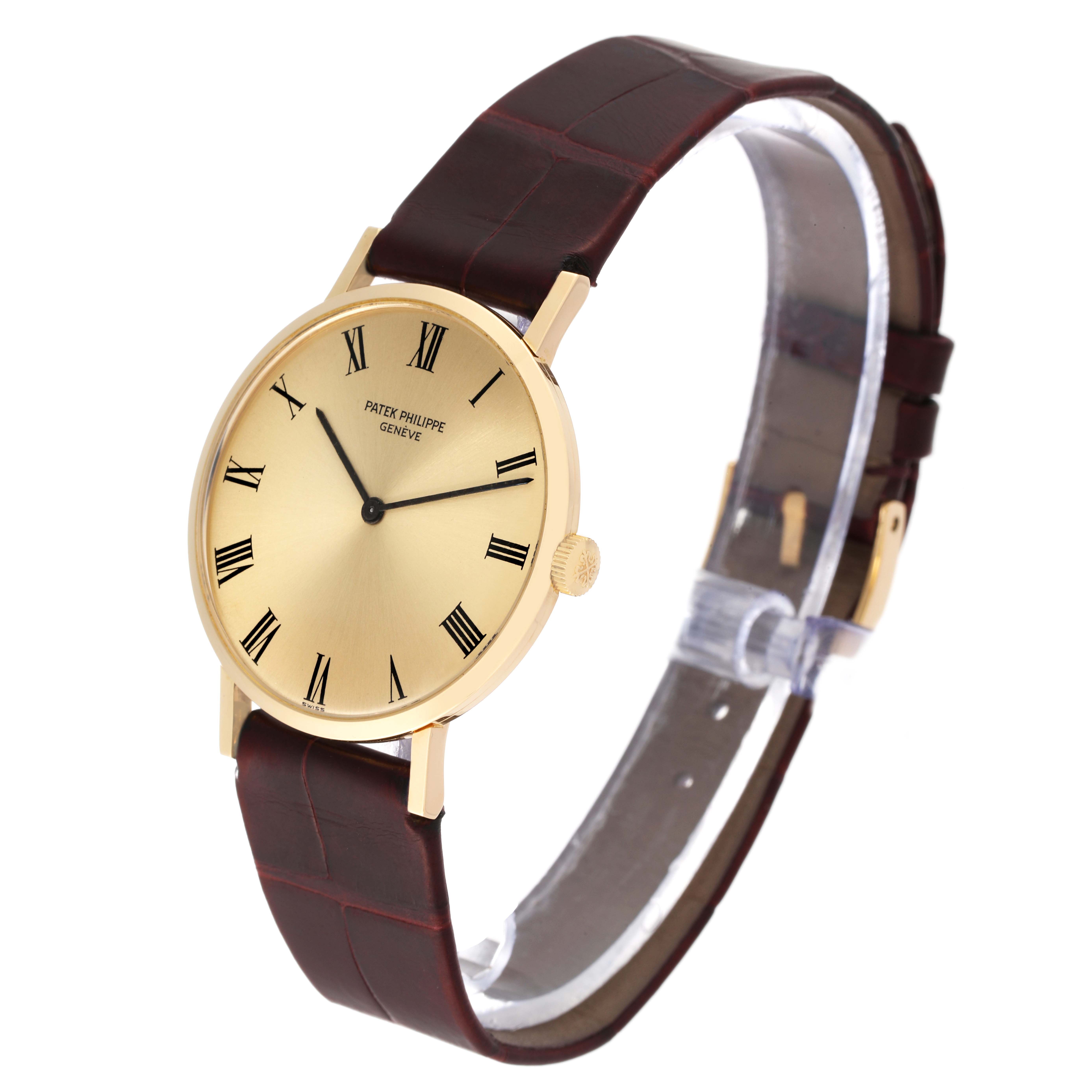 The image shows a side angle of a Patek Philippe Calatrava 3537 Men's Yellow Gold Champagne Dial 3537 Men's Yellow Gold Champagne Dial watch, highlighting its gold case, Roman numeral dial, and brown leather strap.