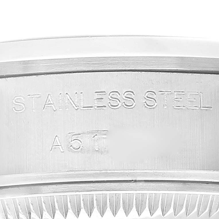 The image shows a close-up of the side of a Rolex Date 79160 Women's Stainless Steel White Dial 79160 Women's Stainless Steel White Dial model watch, highlighting the stainless steel engraving.