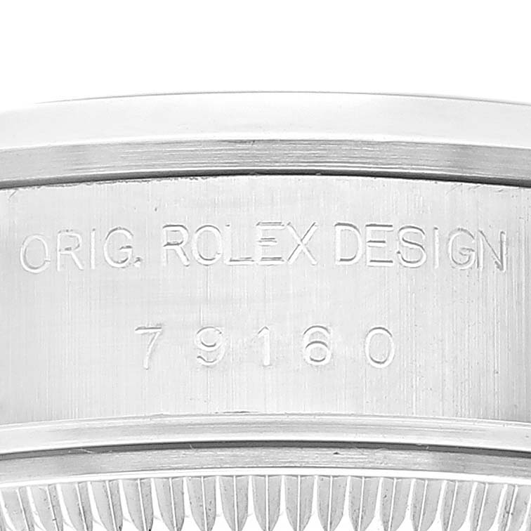 The image shows a close-up side view of the casing of a Rolex Date 79160 Women's Stainless Steel White Dial 79160 Women's Stainless Steel White Dial model watch, featuring the engraved design and model number.