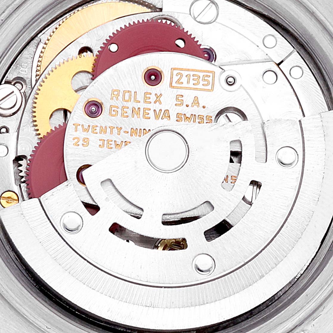 The image shows the movement mechanism of a Rolex Datejust 69173 Women's Steel and Gold (two tone) Champagne Dial 69173 Women's Steel and Gold (two tone) Champagne Dial watch, highlighting cogwheels and the engraved rotor.