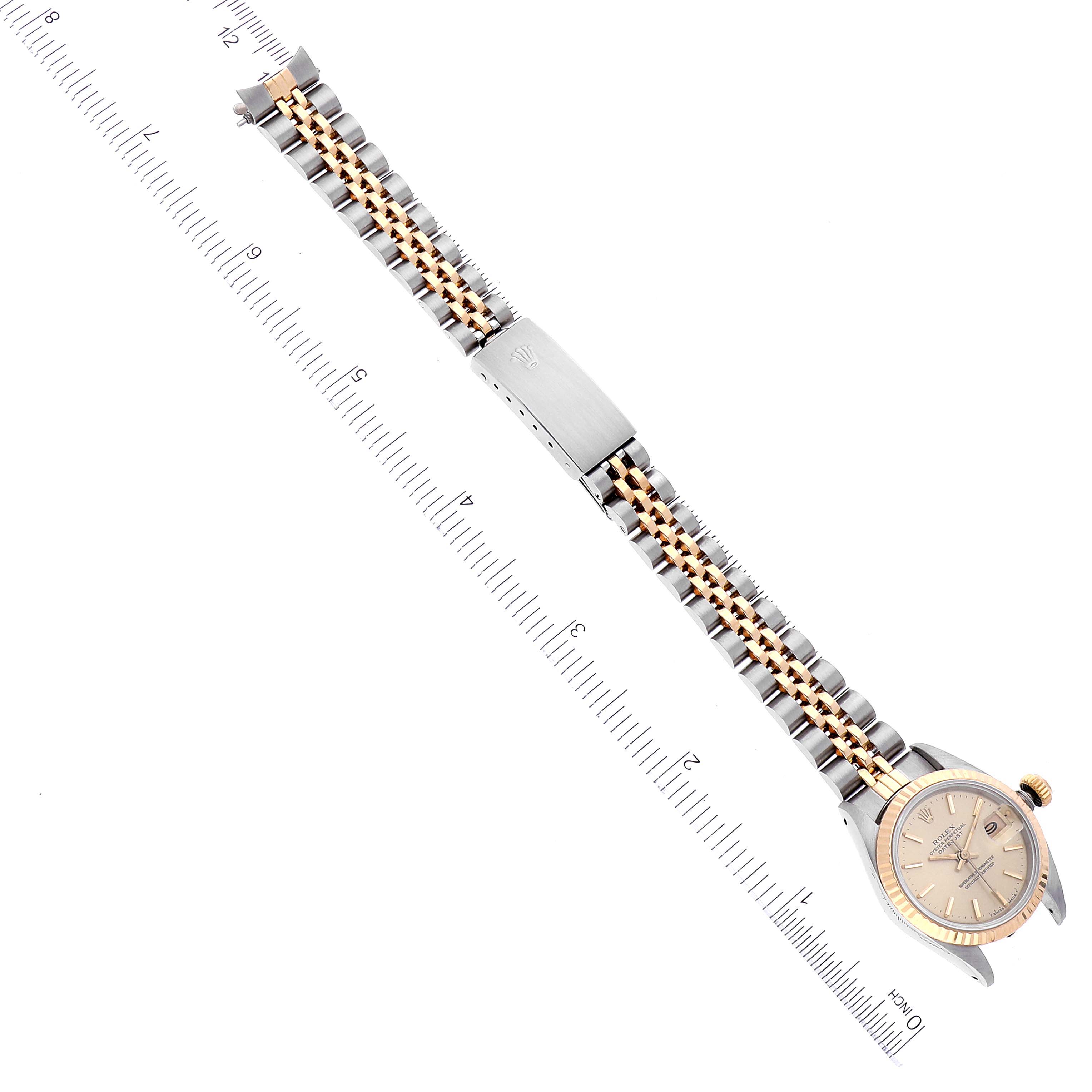 The Rolex Datejust 69173 Women's Steel and Gold (two tone) Champagne Dial 69173 Women's Steel and Gold (two tone) Champagne Dial watch is shown from a top-down angle, displaying the entire watch including its bracelet and clasp.