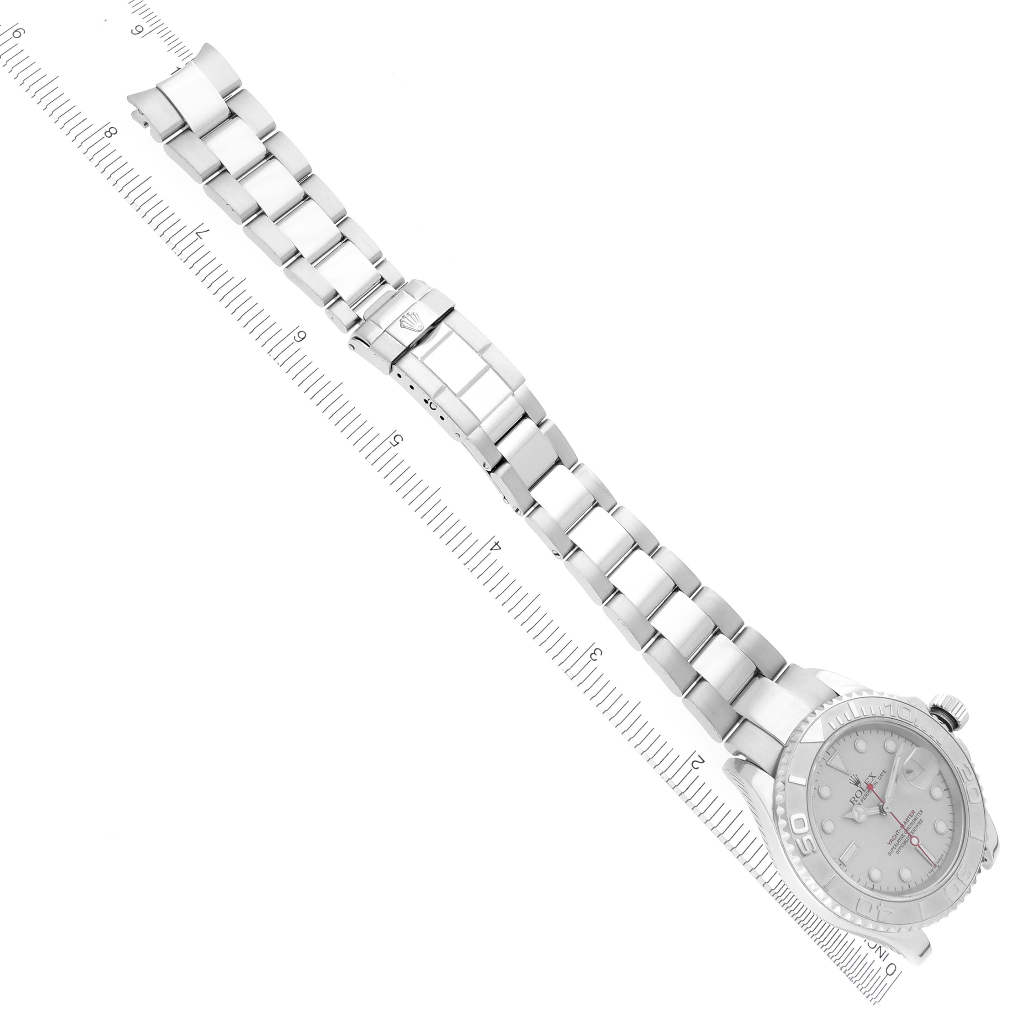 The Rolex Yacht-Master 16622 Men's Stainless Steel Silver Dial 16622 Men's Stainless Steel Silver Dial watch is shown from above, displaying the full bracelet and watch face alongside a ruler for scale.