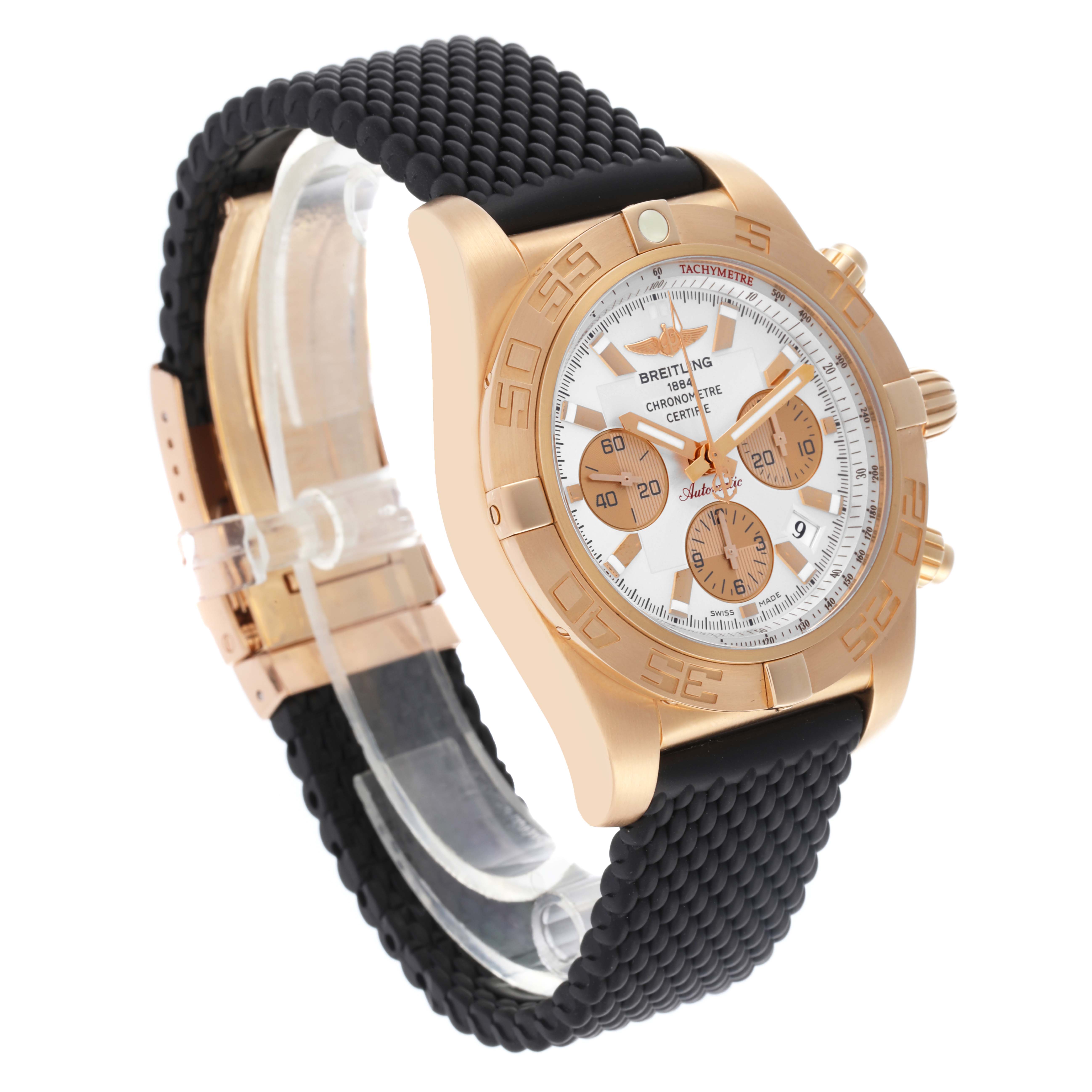 The Breitling Chronomat HB0110 Men's Rose Gold Silver Dial HB0110 Men's Rose Gold Silver Dial watch is shown at an angle, highlighting the watch face, bezel, and textured black strap.
