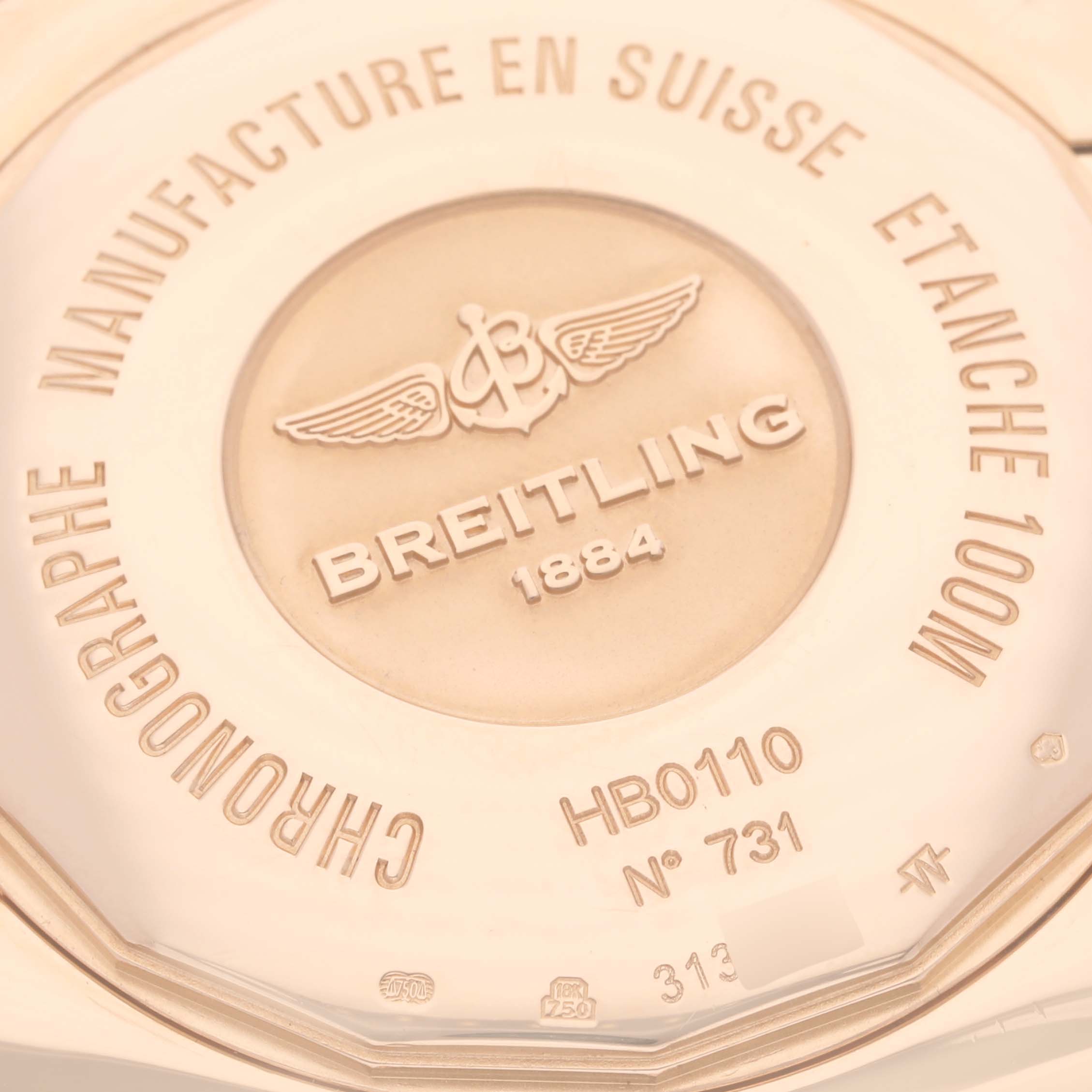 The image shows the case back of the Breitling Chronomat HB0110 Men's Rose Gold Silver Dial HB0110 Men's Rose Gold Silver Dial watch, highlighting its engravings and logo.