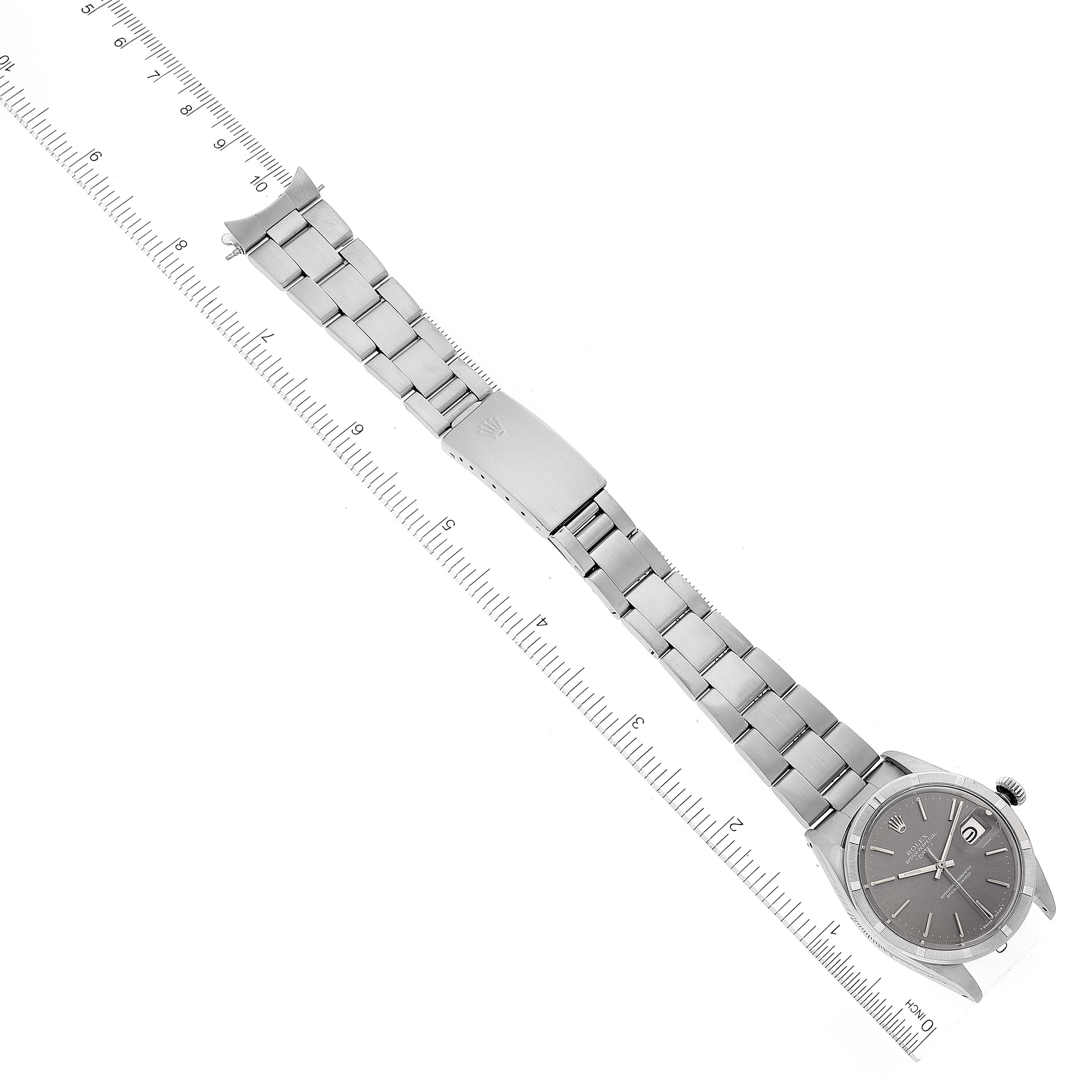 The image shows a Rolex Date 1501 Men's Stainless Steel Grey Dial 1501 Men's Stainless Steel Grey Dial model watch laying flat with a ruler on each side, highlighting the band and face.