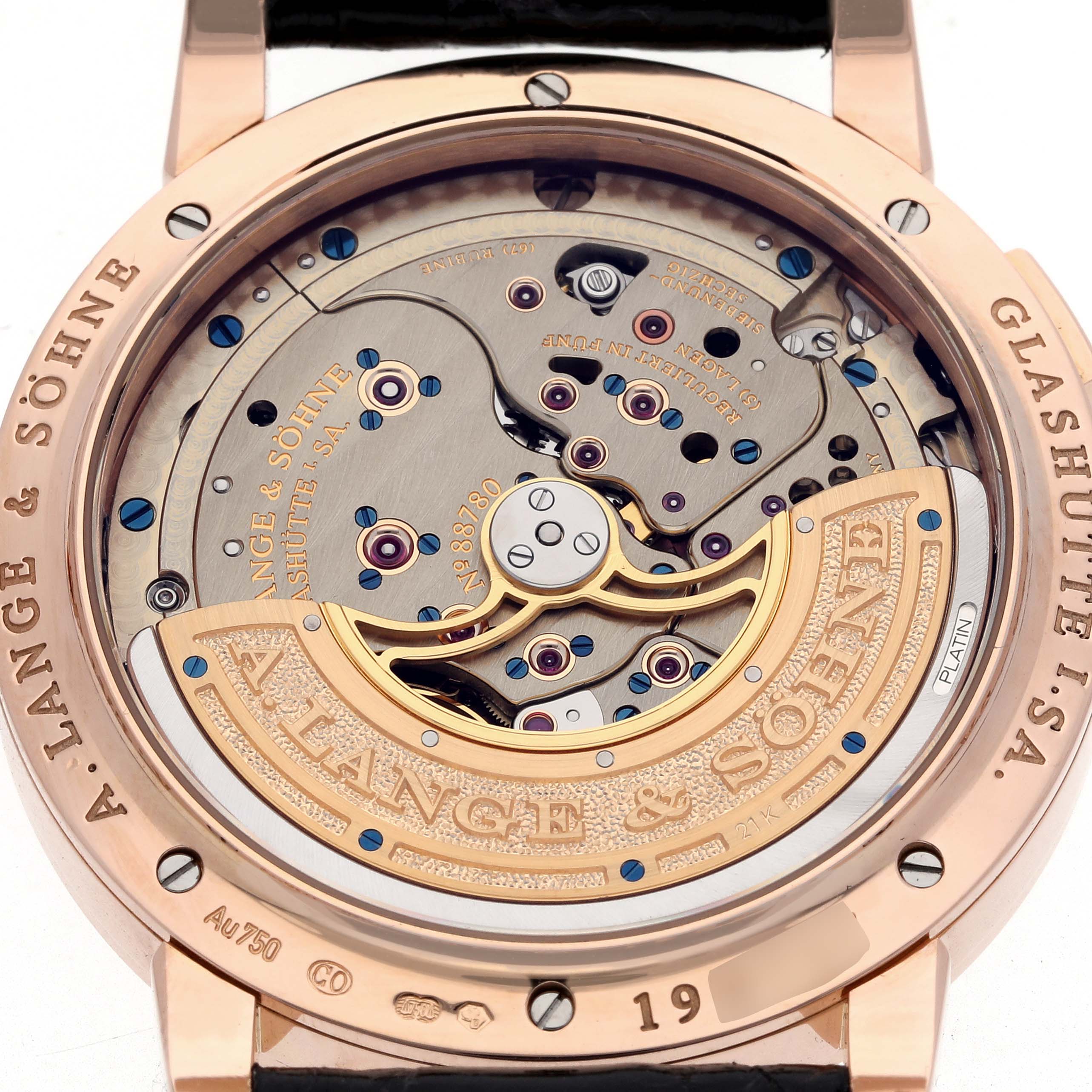 The image shows the back of the Lange 1 by A. Lange & Söhne, highlighting its intricate movement and rotor.