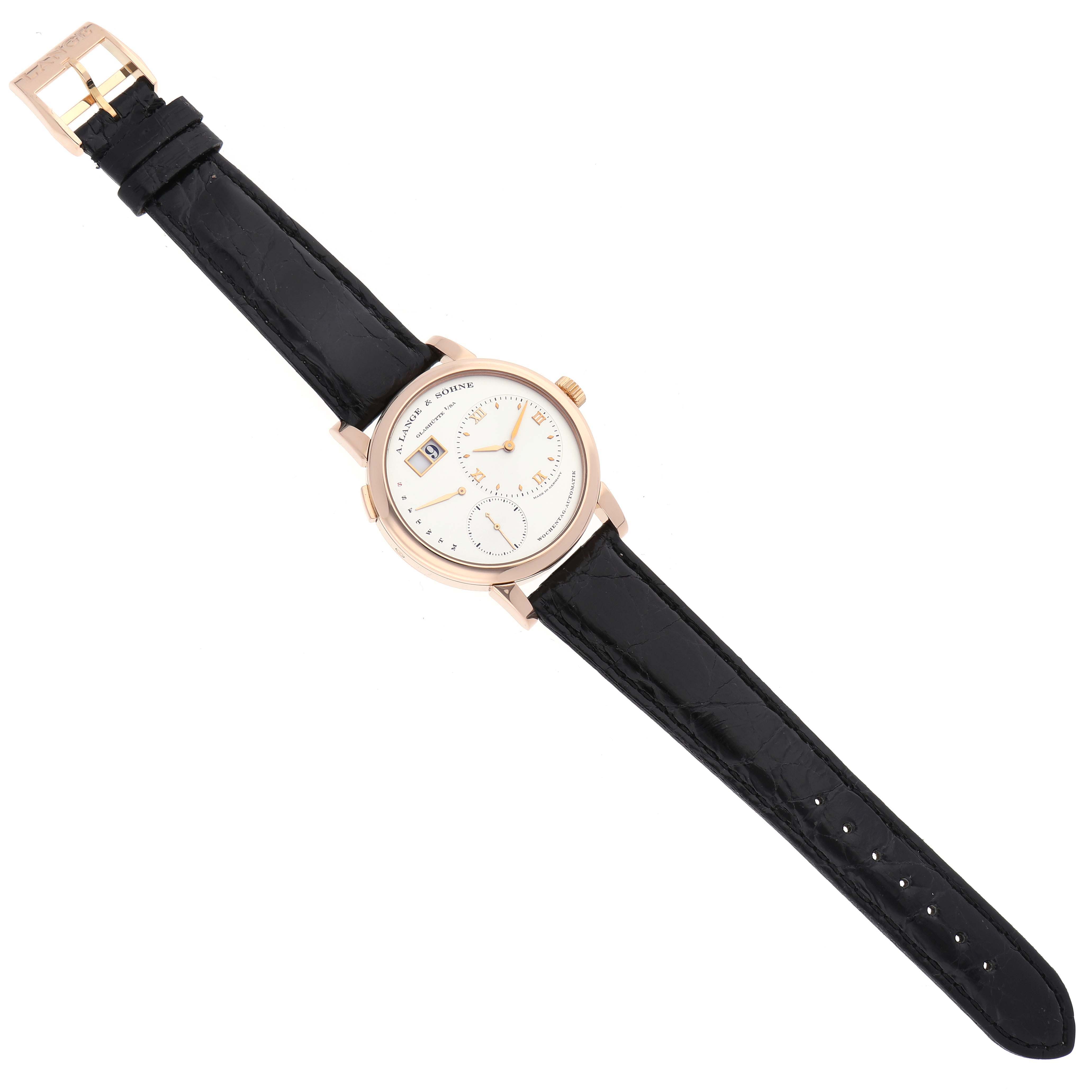 The A. Lange & Sohne Lange 1 320.032 Men's Rose Gold Silver Dial watch is shown from a top-down angle, displaying the entire face and black leather strap.