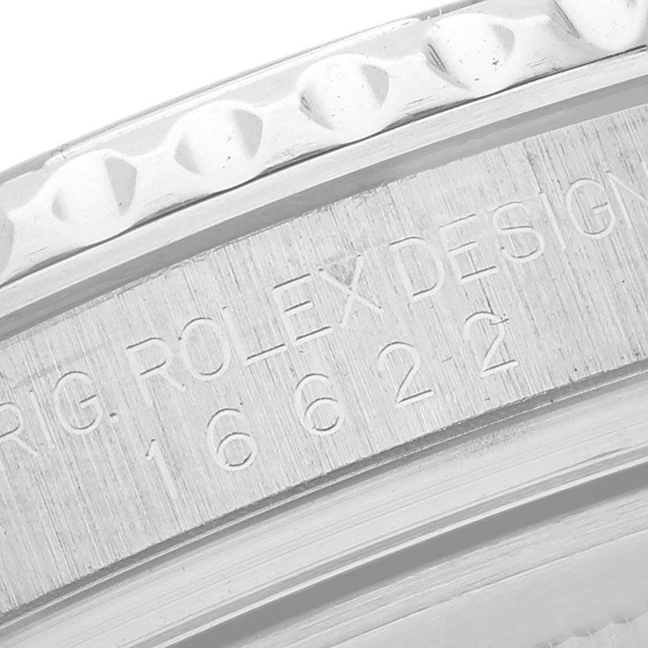 The image shows a close-up of the Rolex Yacht-Master 16622 Men's Stainless Steel Silver Dial 16622 Men's Stainless Steel Silver Dial model's engraved bezel and case edge.