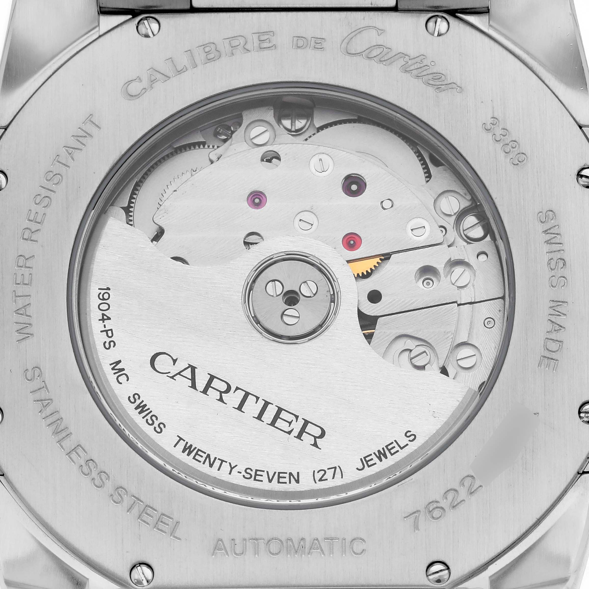 The image shows the back of a Calibre de Cartier watch, highlighting the automatic movement and engravings.