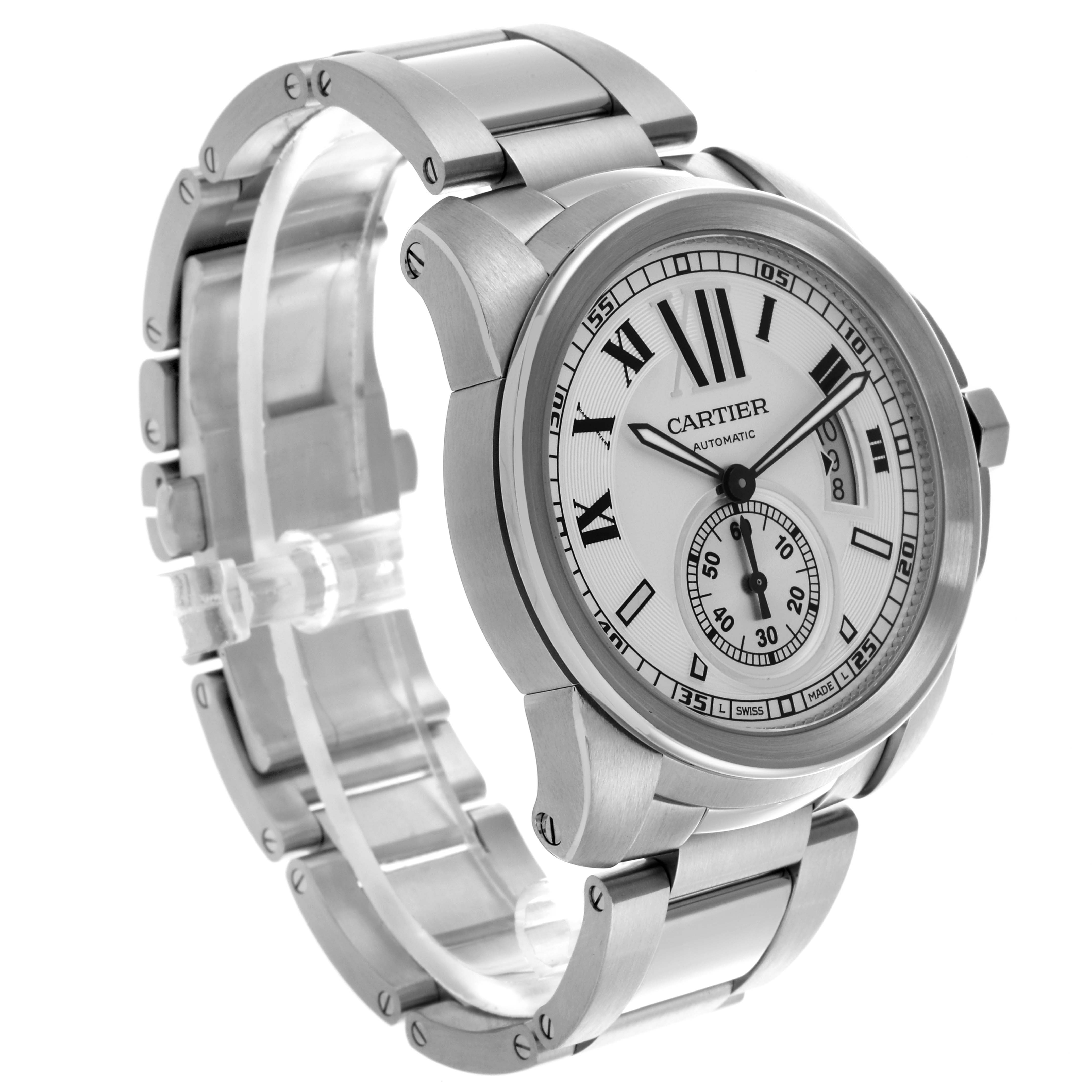The Calibre de Cartier watch is shown at a three-quarter angle, highlighting its face, bezel, and bracelet.