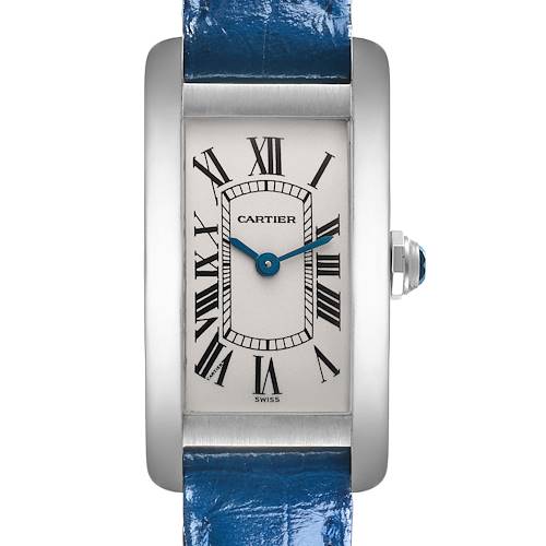 The Cartier Tank Américaine watch is shown from a front angle, displaying its face, Roman numerals, and part of the blue strap.