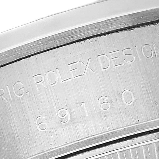 This image shows a close-up of the inner bezel of a Rolex Date 69160 Women's Stainless Steel White Dial 69160 Women's Stainless Steel White Dial model, highlighting the engravings.
