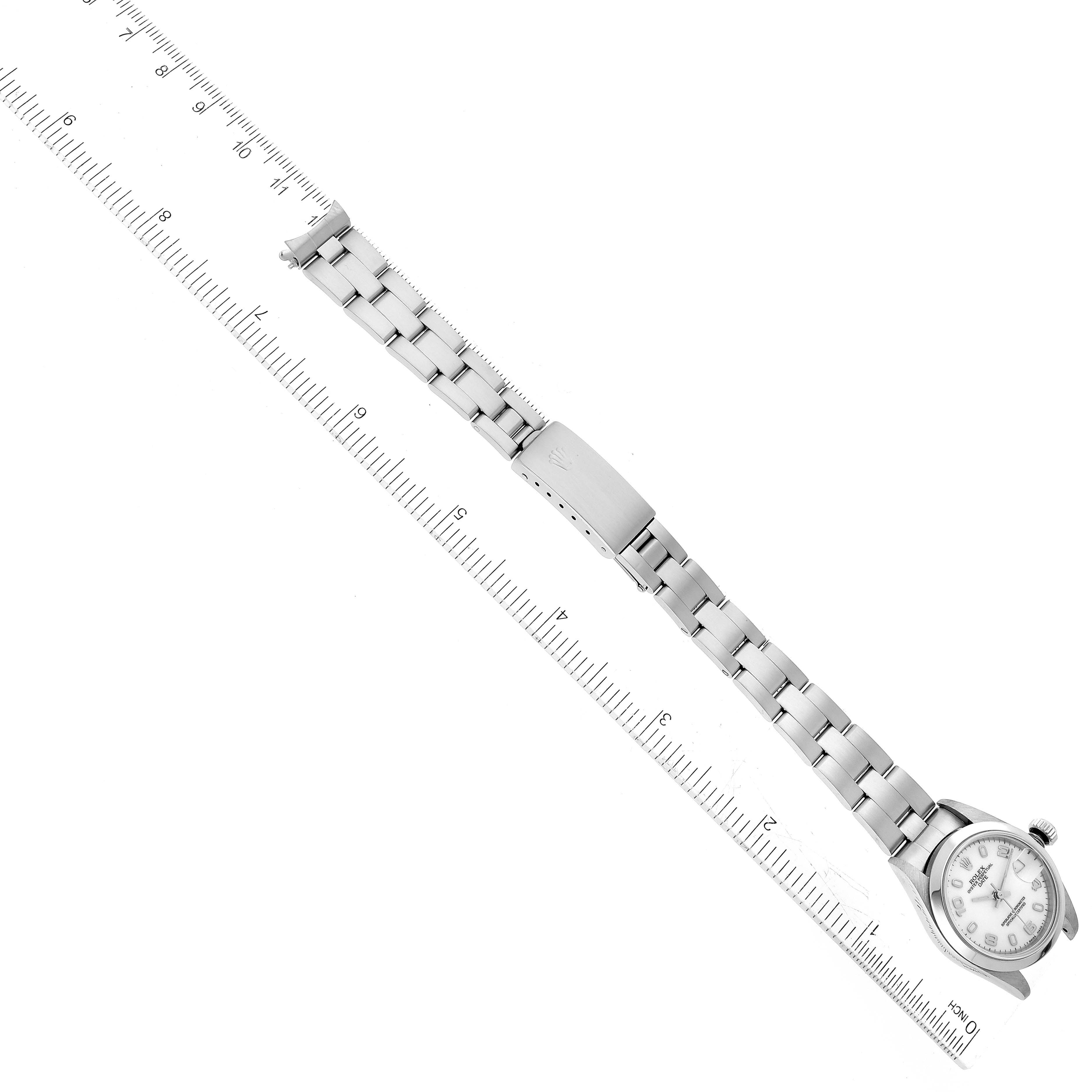 The image shows a Rolex Date 69160 Women's Stainless Steel White Dial 69160 Women's Stainless Steel White Dial model watch with a ruler measuring its bracelet length at an overhead angle.