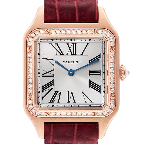 This image shows a close-up of a Cartier Santos WJSA0016 Women's Rose Gold Silver Dial WJSA0016 Women's Rose Gold Silver Dial watch face and part of its leather strap bezel adorned with diamonds.