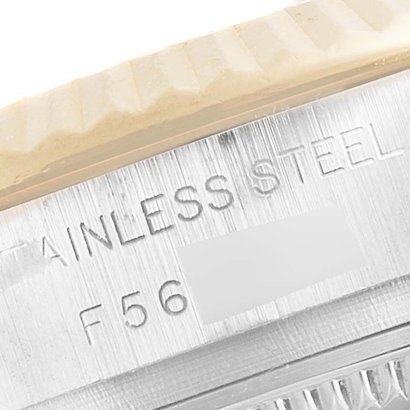 This close-up image of a Rolex Datejust 179173 Women's Steel and Gold (two tone) Mother of Pearl Dial 179173 Women's Steel and Gold (two tone) Mother of Pearl Dial watch shows part of the stainless steel case with engraved markings.