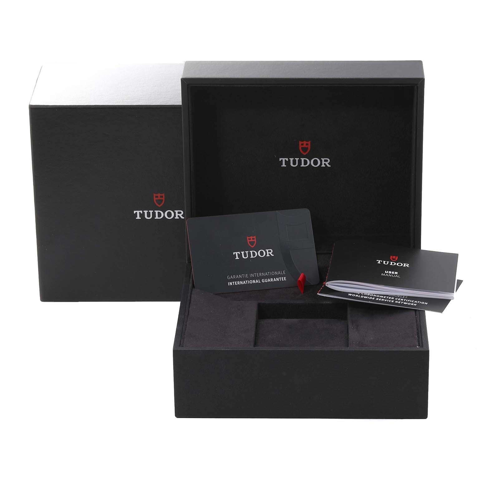 The image shows the open packaging box for the Tudor Pelagos 25610TNL Men's Titanium Black Dial 25610TNL Men's Titanium Black Dial, including the guarantee card and manual, viewed from the front.