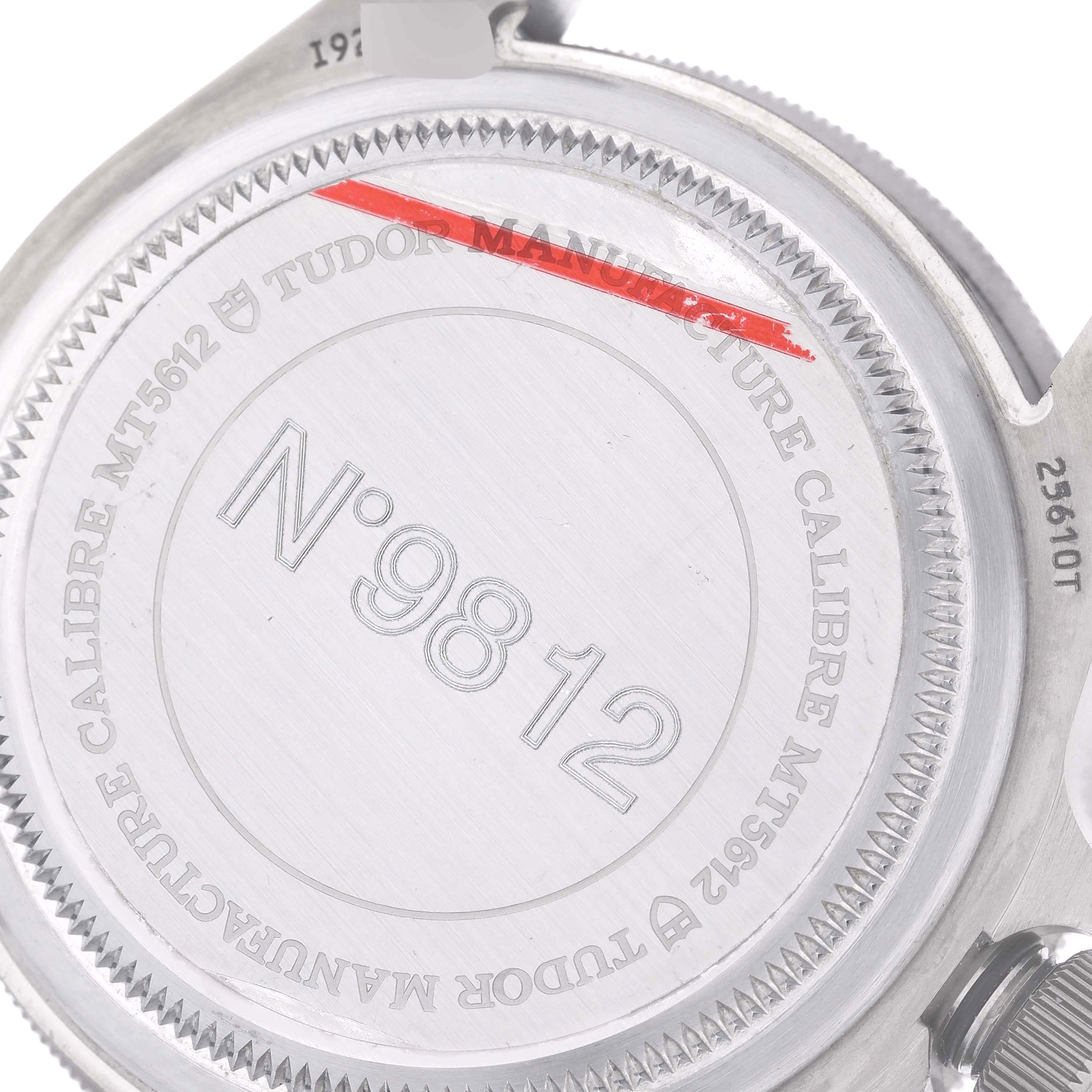 The image displays the case back of a Tudor Pelagos 25610TNL Men's Titanium Black Dial 25610TNL Men's Titanium Black Dial watch, showing engravings and the model number MT5612.