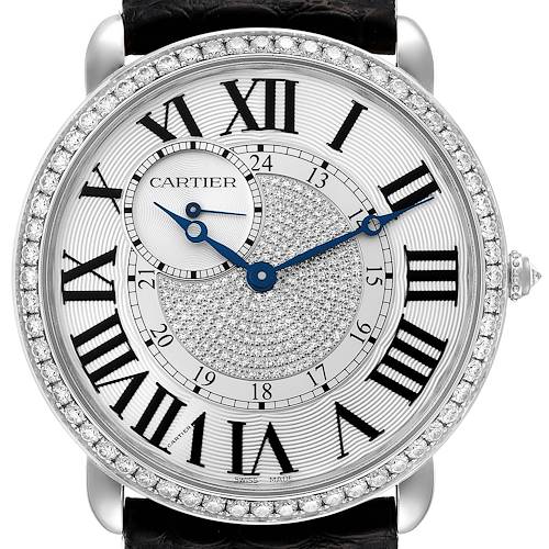 This image displays a close-up of the Cartier Tank Louis watch face, highlighting its Roman numerals, diamond bezel, and blue hands.