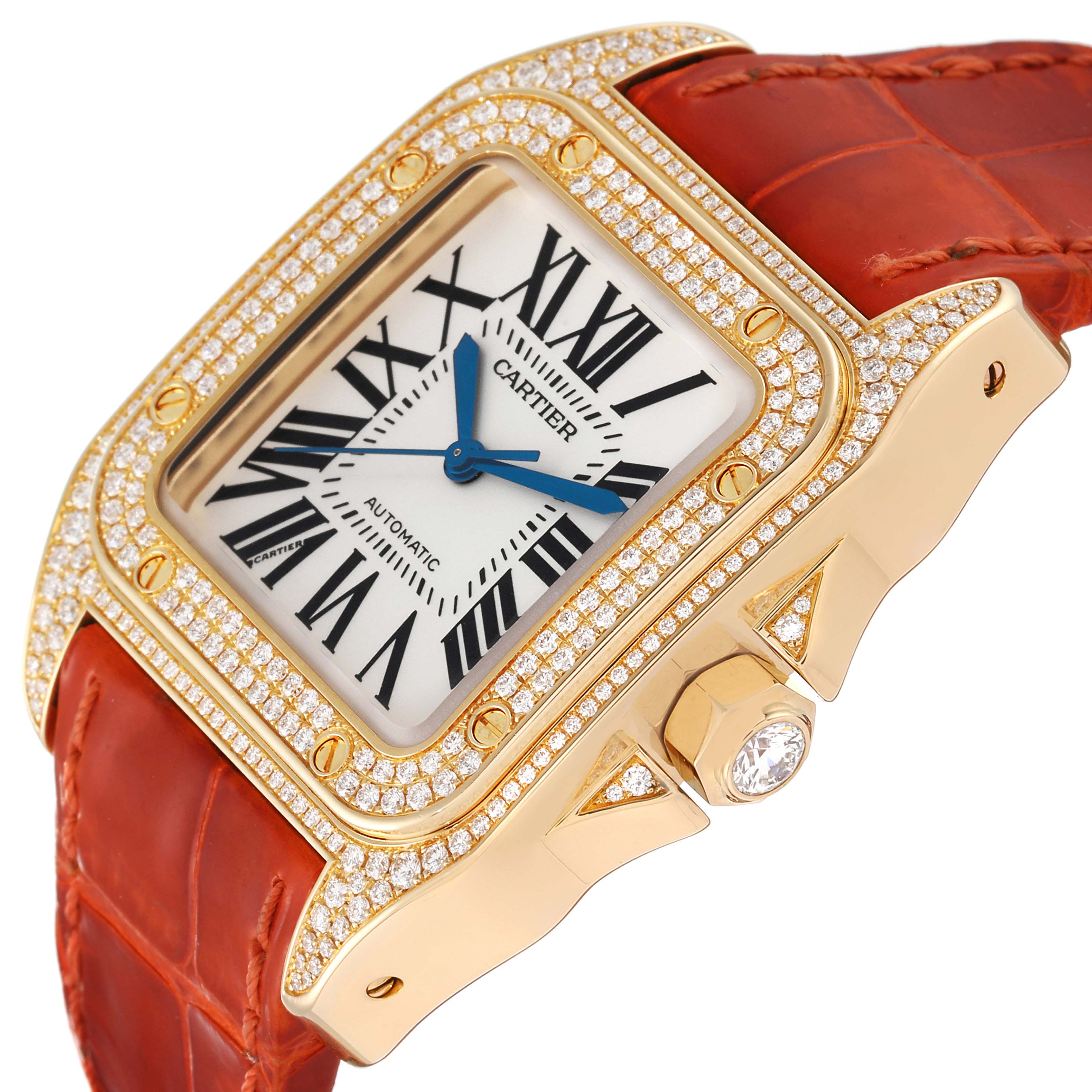 This image shows a close-up angle of the Cartier Santos WM502051 Men's Yellow Gold Silver Dial WM502051 Men's Yellow Gold Silver Dial watch, highlighting its diamond-studded bezel, face, and orange leather strap.