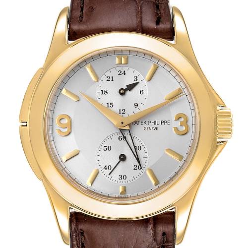 The image shows a front view of a Patek Philippe Calatrava 5134J Men's Yellow Gold White Dial 5134J Men's Yellow Gold White Dial watch with a gold case and brown leather strap.