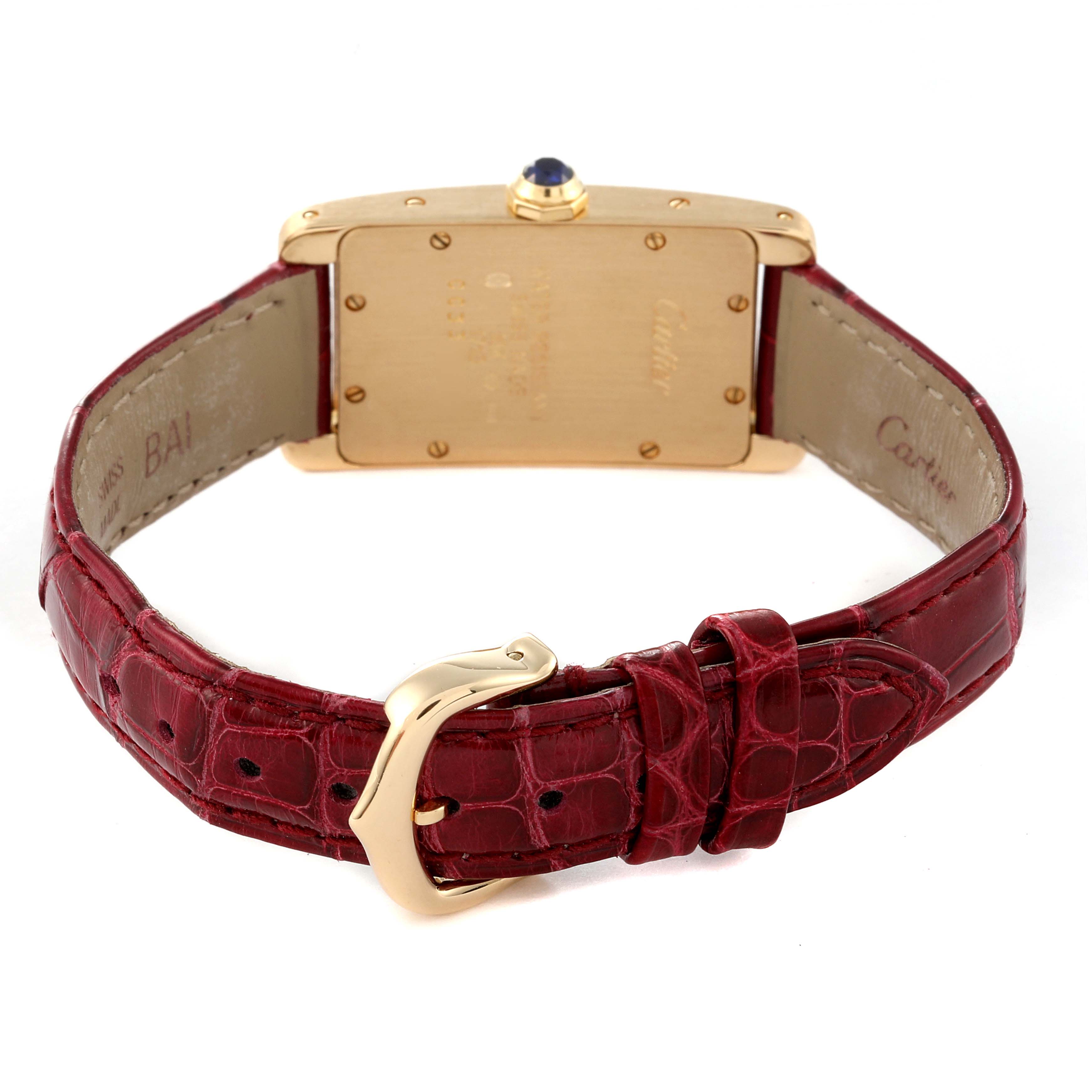 The image shows the back view of the Cartier Tank Americaine W2601556 Women's Yellow Gold Silver Dial W2601556 Women's Yellow Gold Silver Dial watch, displaying its gold case and red leather strap with a buckle.