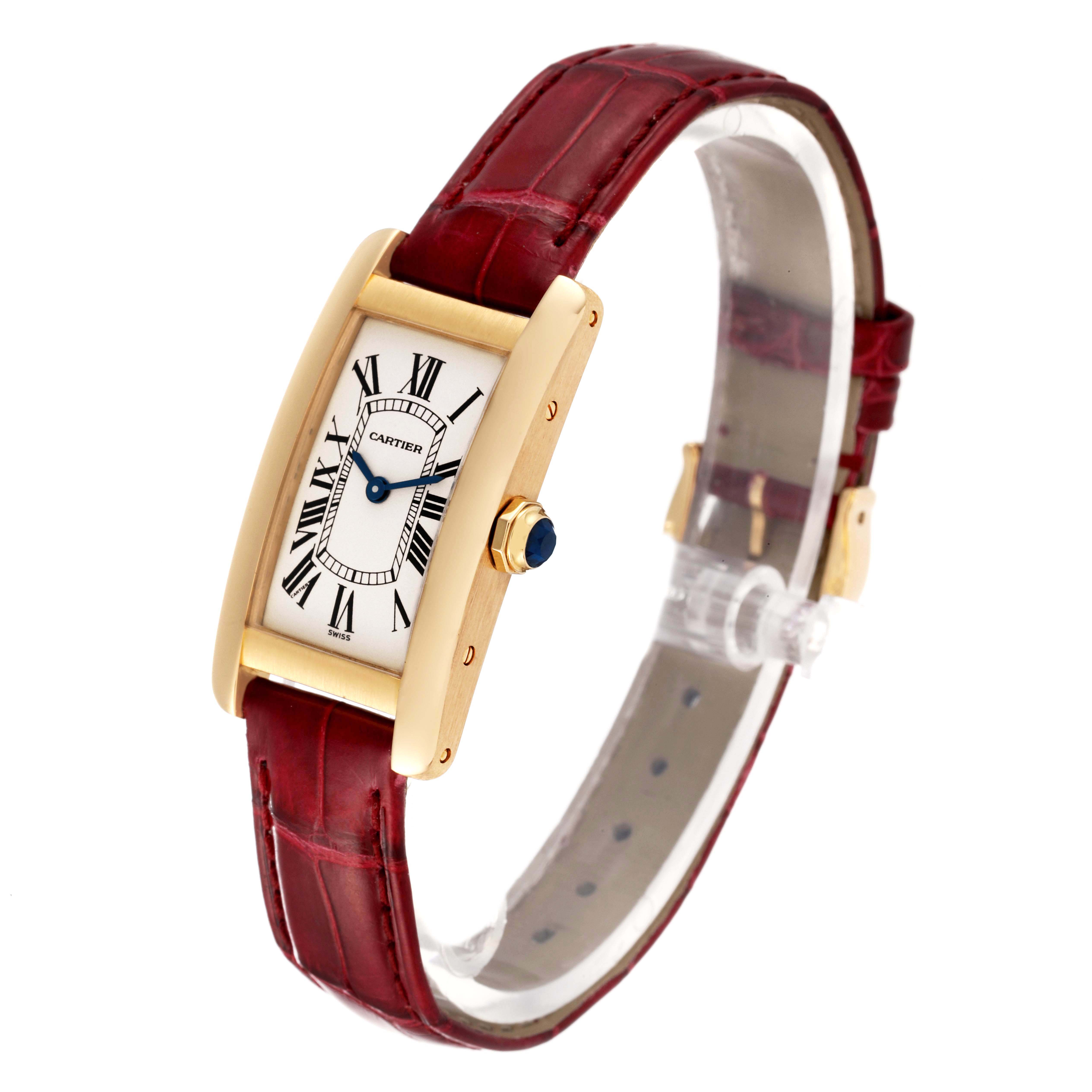 The image shows a Cartier Tank Americaine W2601556 Women's Yellow Gold Silver Dial W2601556 Women's Yellow Gold Silver Dial watch at a side angle, displaying its red strap, gold case, and Roman numeral dial.