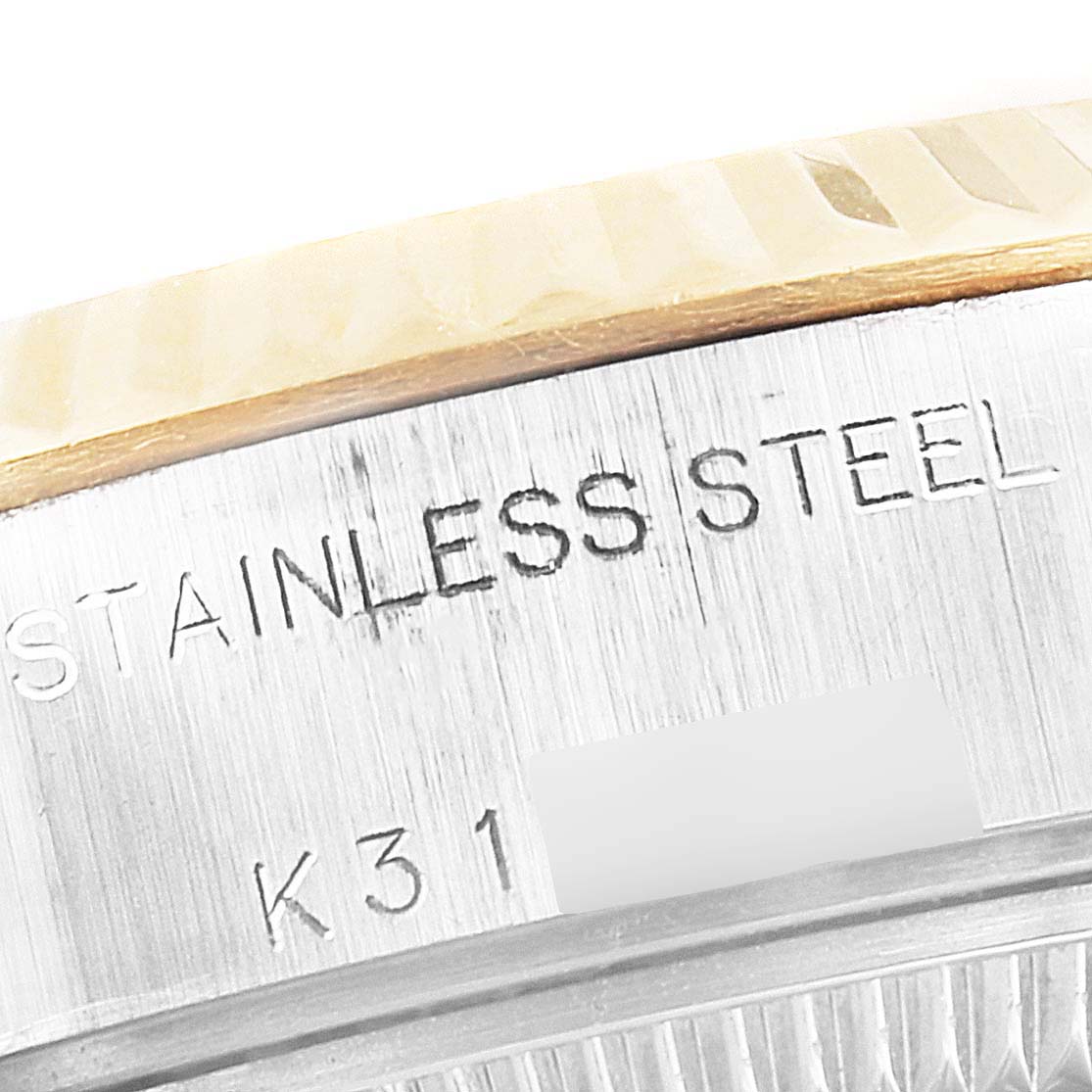 This image shows a close-up of the stainless steel part of a Rolex Datejust 79173 Women's Steel and Gold (two tone) Champagne Dial 79173 Women's Steel and Gold (two tone) Champagne Dial watch, including the engraving.