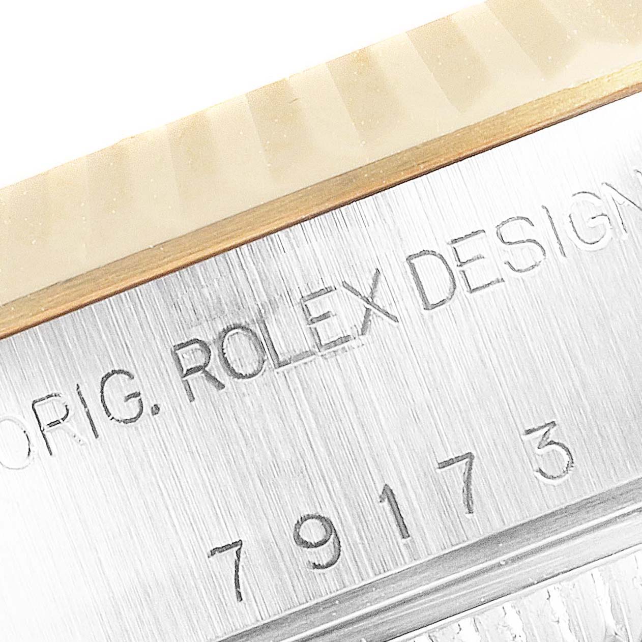 The image shows a close-up of the engraved serial number on a Rolex Datejust 79173 Women's Steel and Gold (two tone) Champagne Dial 79173 Women's Steel and Gold (two tone) Champagne Dial model watch bezel.