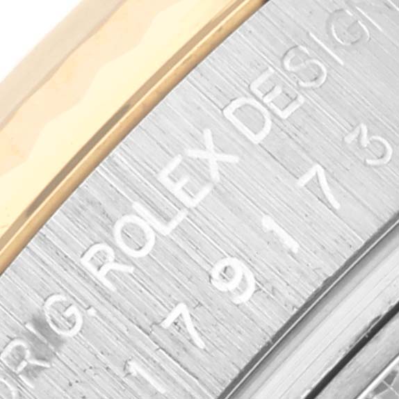 The image shows the side view of the bezel and engraved serial number detail of a Rolex Datejust 179173 Women's Steel and Gold (two tone) Beige Dial 179173 Women's Steel and Gold (two tone) Beige Dial watch.