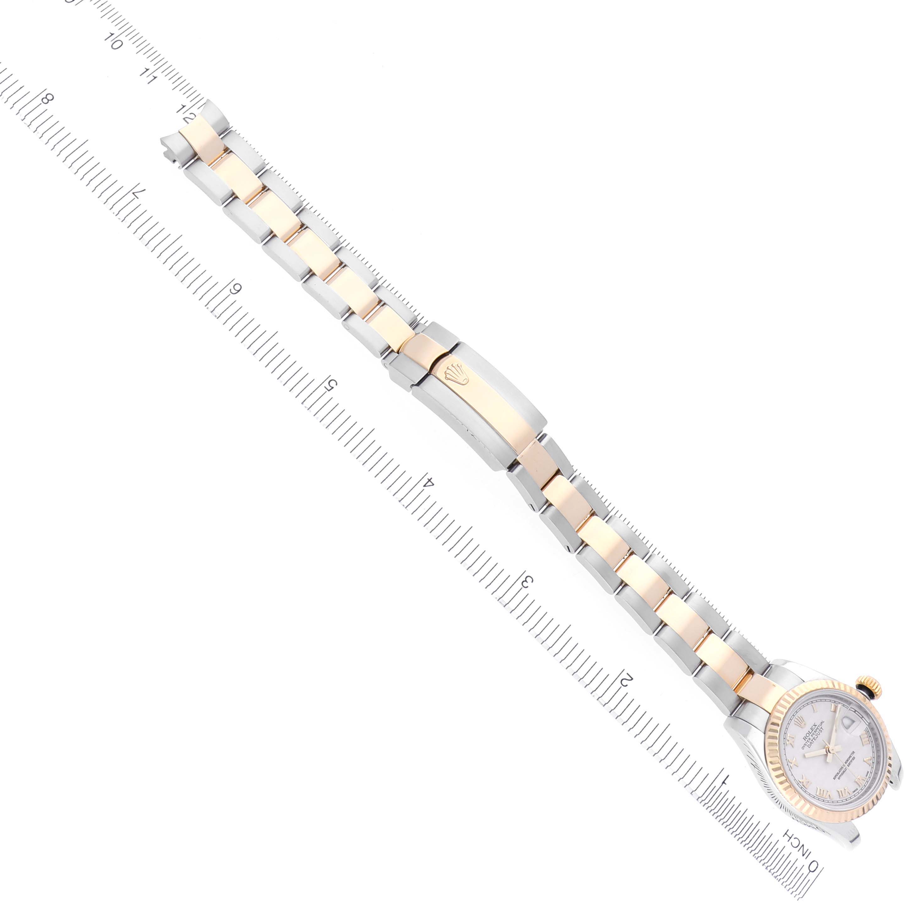 The Rolex Datejust 179173 Women's Steel and Gold (two tone) Beige Dial 179173 Women's Steel and Gold (two tone) Beige Dial watch is shown from an overhead angle, displaying the full bracelet, clasp, and face.
