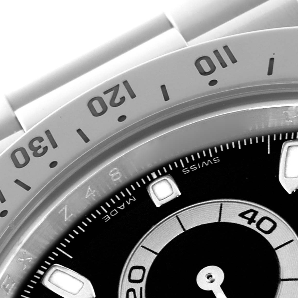 The image shows a close-up of the bezel and part of the dial of a Rolex Daytona 116520 Men's Stainless Steel Black Dial 116520 Men's Stainless Steel Black Dial watch, displaying numbers and indices.
