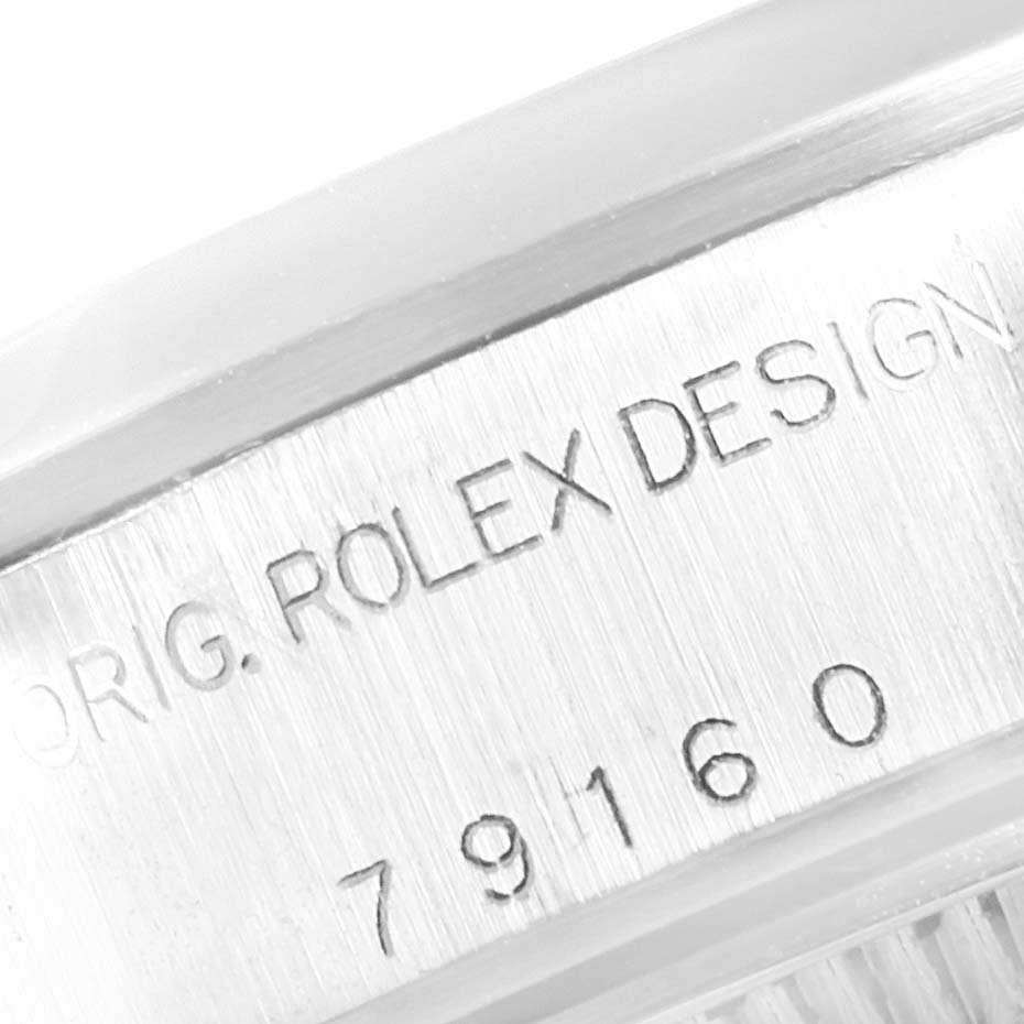 This image shows a close-up of the side of a Rolex Date 79160 Women's Stainless Steel White Dial 79160 Women's Stainless Steel White Dial model, focusing on the engraved serial number and "ORIG. ROLEX DESIGN."
