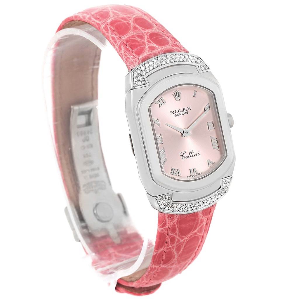 This Rolex Cellini 6692 Women's White Gold Pink Dial 6692 Women's White Gold Pink Dial watch is shown from a diagonal angle, highlighting its pink dial, silver case with diamonds, and pink strap.