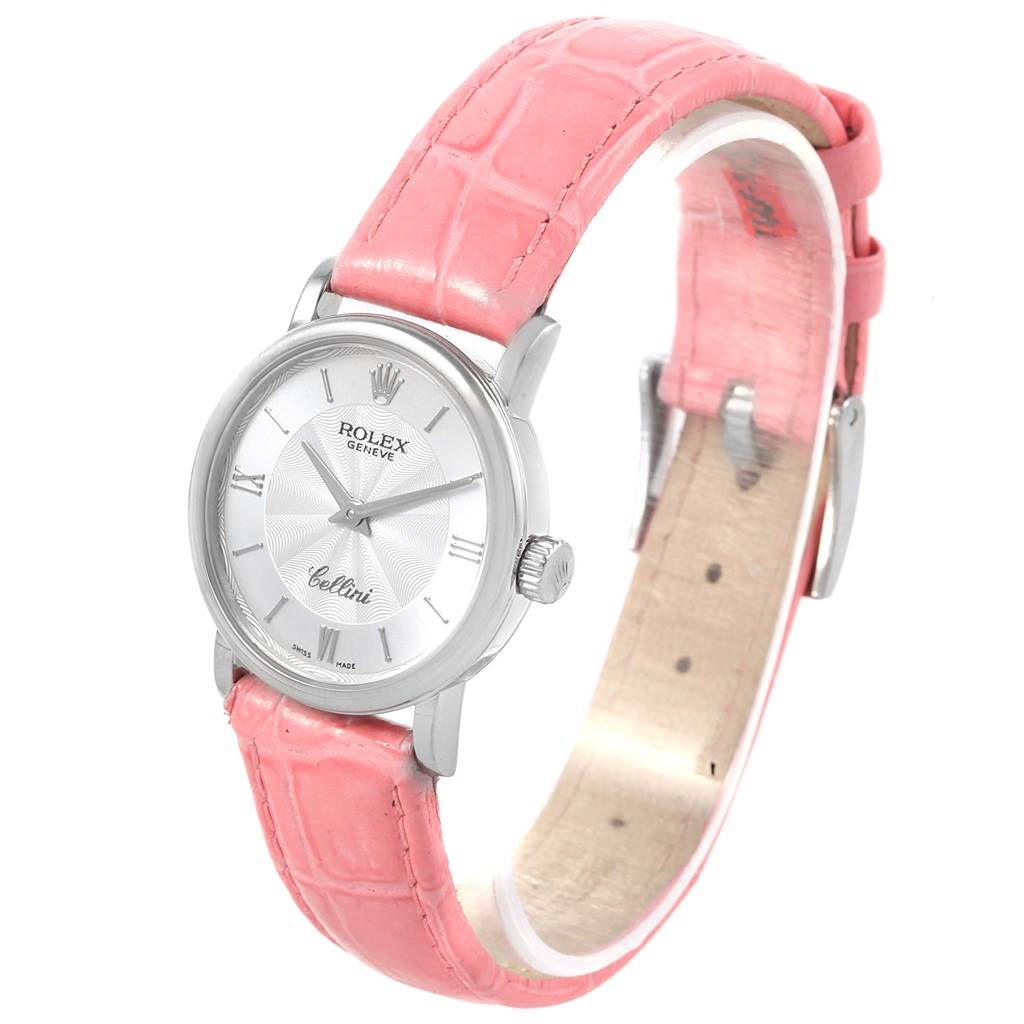 This image shows the front and partial side view of a Rolex Cellini 6110 Women's White Gold Silver Dial 6110 Women's White Gold Silver Dial watch with a pink leather strap.