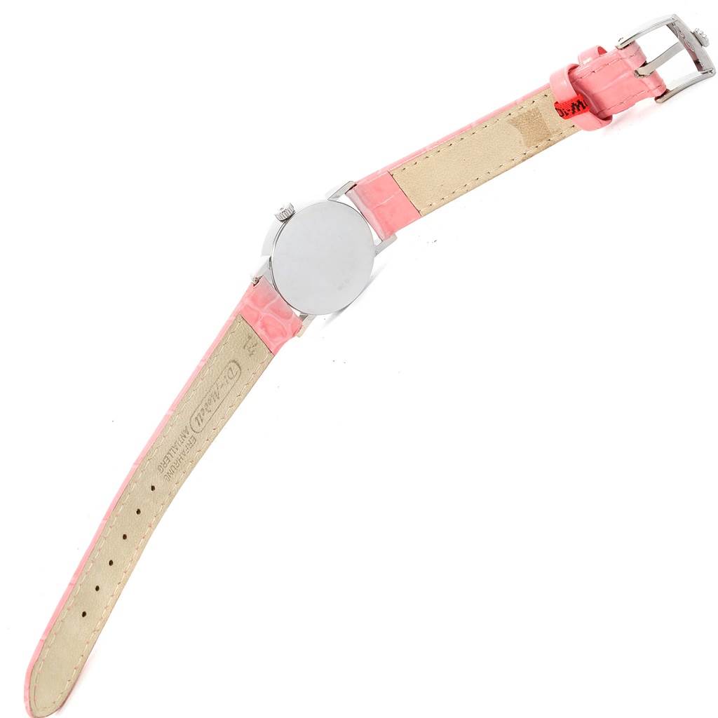 This Rolex Cellini 6110 Women's White Gold Silver Dial 6110 Women's White Gold Silver Dial watch shot shows its back case, pink leather strap, and buckle from an angled overhead view.