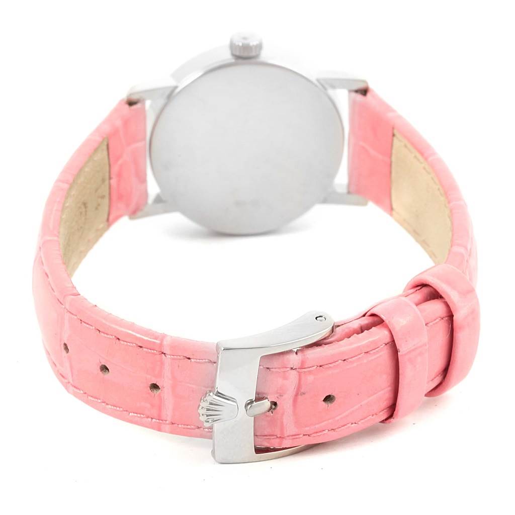 The image shows the back of a Rolex Cellini 6110 Women's White Gold Silver Dial 6110 Women's White Gold Silver Dial watch with a pink leather strap and a metal clasp featuring the Rolex logo.