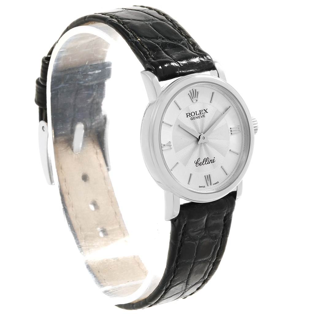 The Rolex Cellini 6110 Women's White Gold Silver Dial 6110 Women's White Gold Silver Dial watch is shown from a left side angle, highlighting the face, crown, and black leather strap.