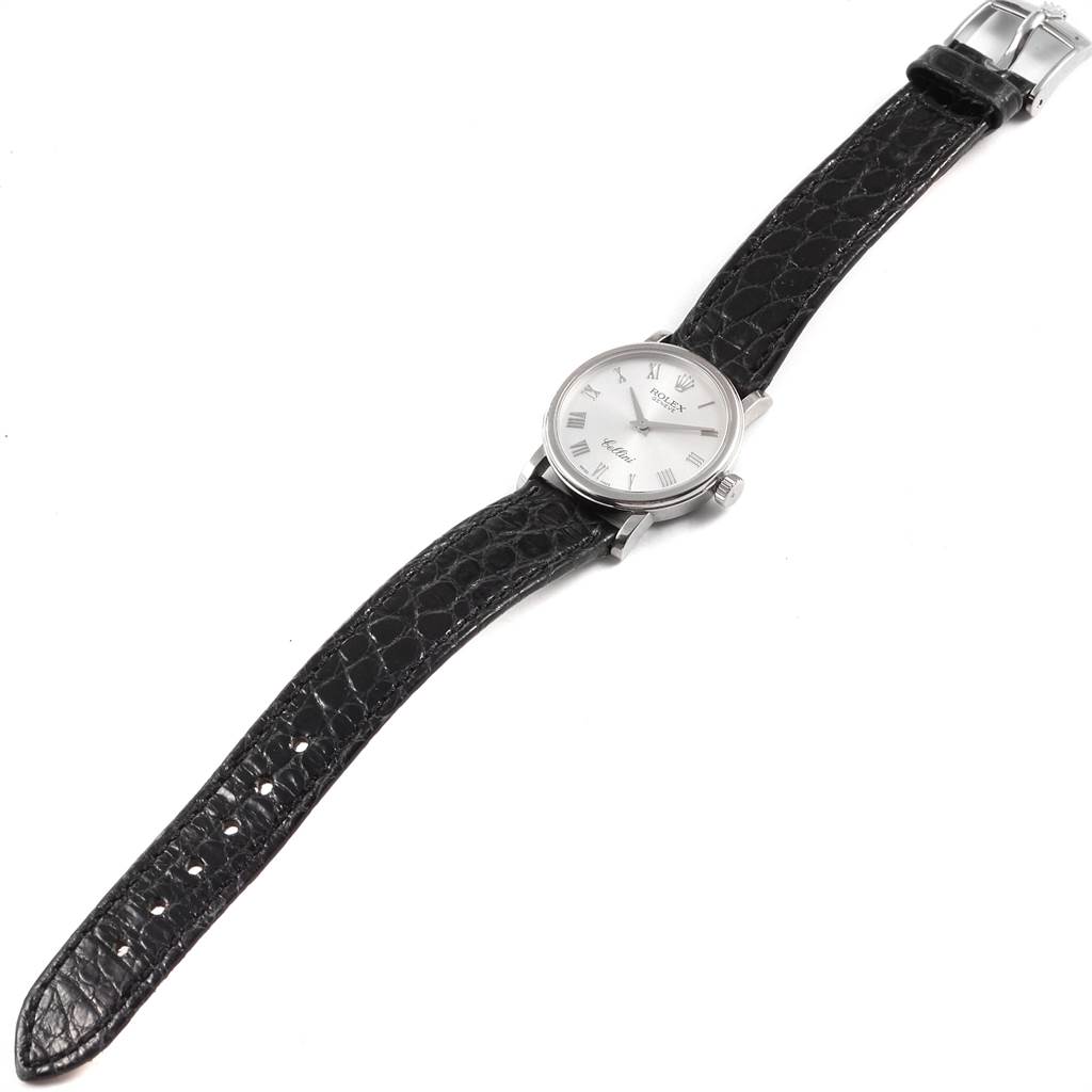 The image shows a full view of a Rolex Cellini 6110 Women's White Gold Silver Dial 6110 Women's White Gold Silver Dial watch with a black leather strap and a silver watch face, photographed from above.