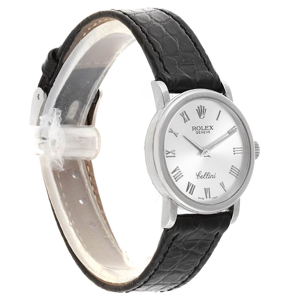 The Rolex Cellini 6110 Women's White Gold Silver Dial 6110 Women's White Gold Silver Dial watch is shown at an angled side view, displaying the watch face, case, and black leather strap.