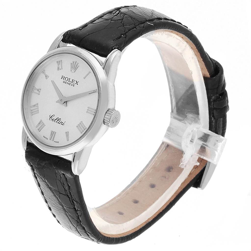 The image shows a Rolex Cellini 6111 Women's White Gold Silver Dial 6111 Women's White Gold Silver Dial watch at an angled side view, featuring its dial, casing, and black leather strap.