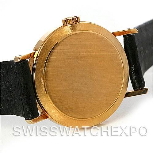 This image shows the back case and crown of a Rolex Cellini 4109 Women's Yellow Gold White Dial 4109 Women's Yellow Gold White Dial watch, with black leather straps partially visible.