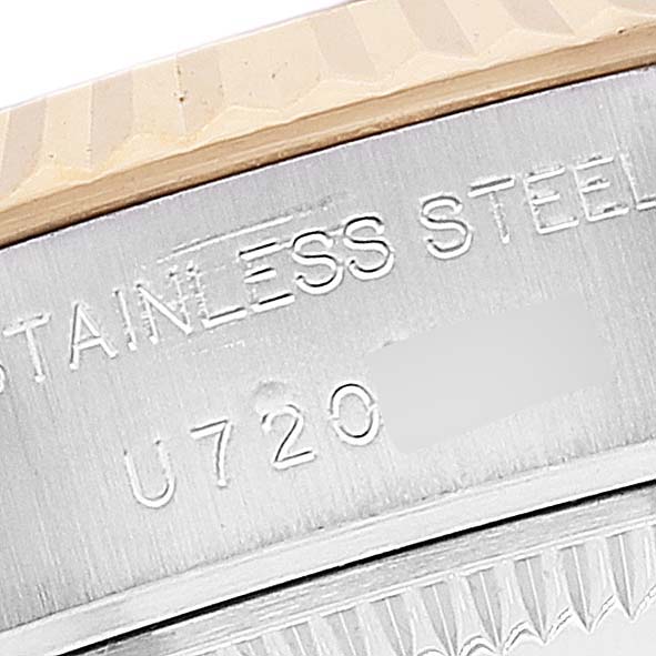 This close-up image shows the stainless steel casing and part of the fluted bezel of a Rolex Datejust 69173 Women's Steel and Gold (two tone) Grey Dial 69173 Women's Steel and Gold (two tone) Grey Dial watch.