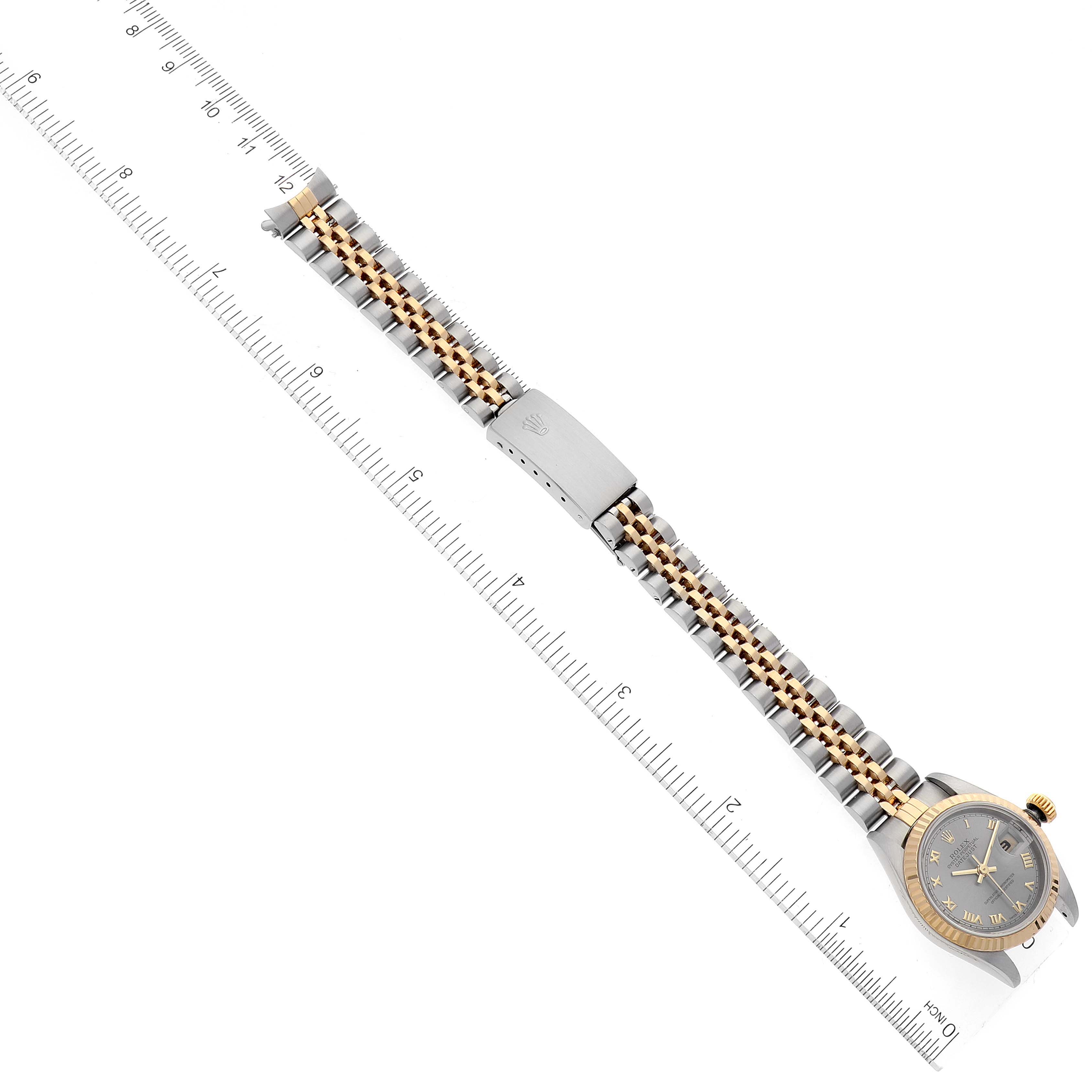 The image shows a top-down view of a Rolex Datejust 69173 Women's Steel and Gold (two tone) Grey Dial 69173 Women's Steel and Gold (two tone) Grey Dial model watch, highlighting the watch face and the two-tone bracelet with a measuring ruler alongside.