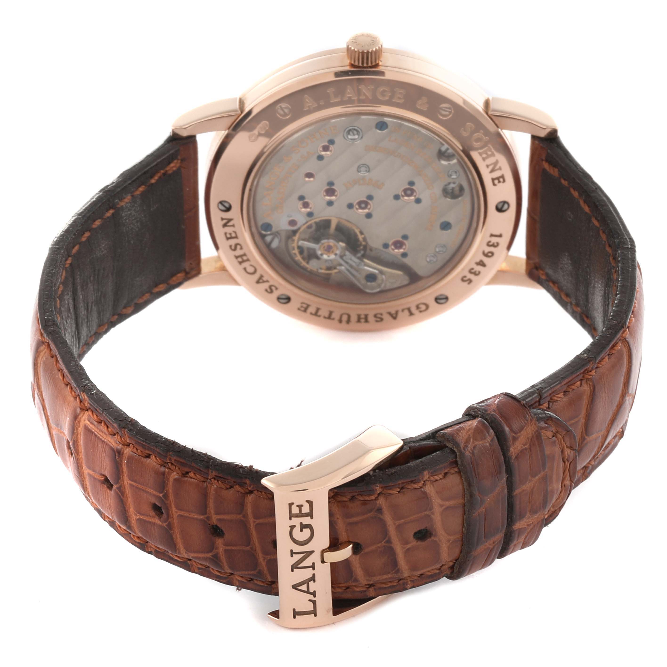 The A. Lange & Sohne 1815 221.032 / LSLS2214AD Men's Rose Gold Silver Dial watch is shown from the rear, displaying the movement and leather strap with a buckle.