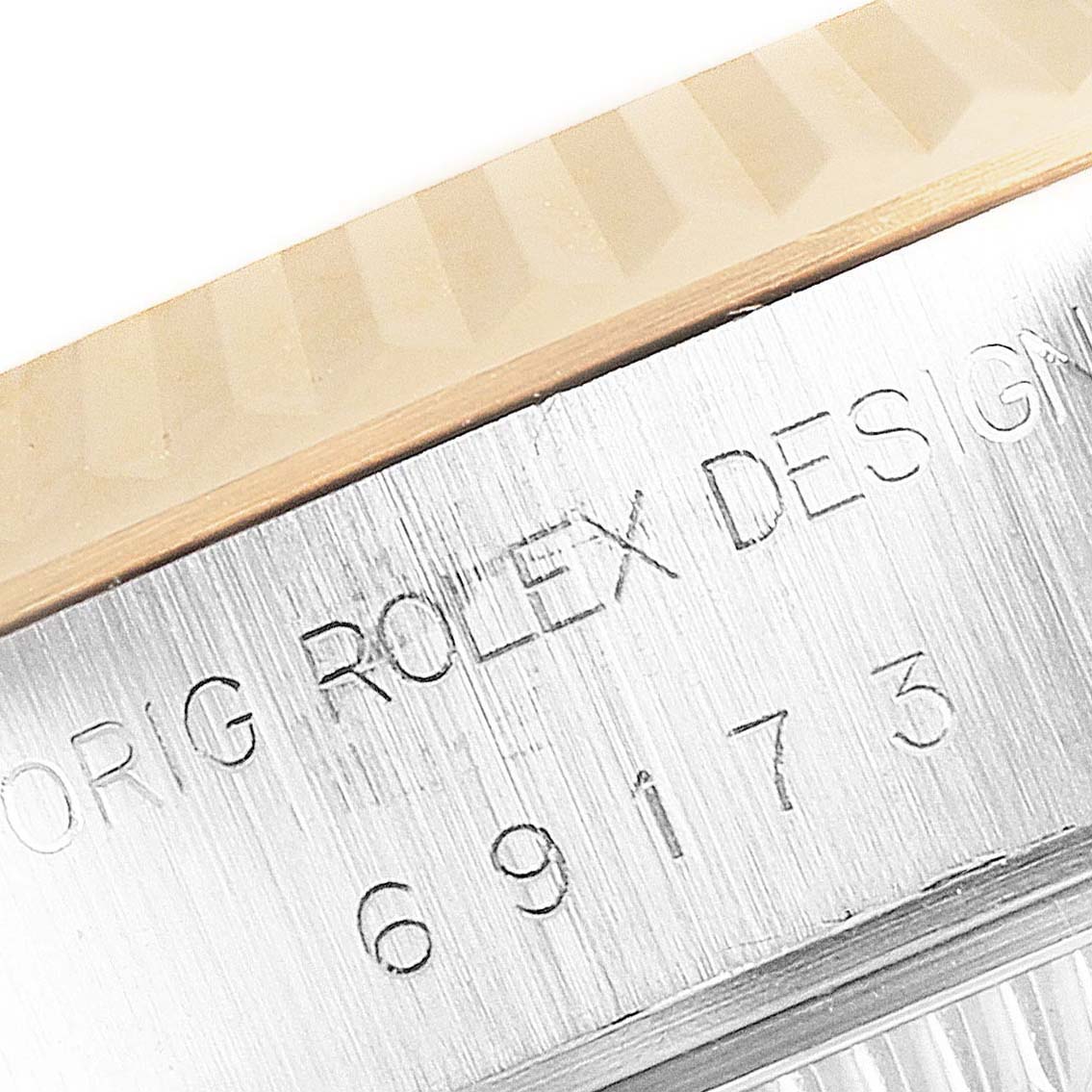 This image shows a close-up view of the engraved bezel and serial number on a Rolex Datejust 69173 Women's Steel and Gold (two tone) Champagne Dial 69173 Women's Steel and Gold (two tone) Champagne Dial watch.