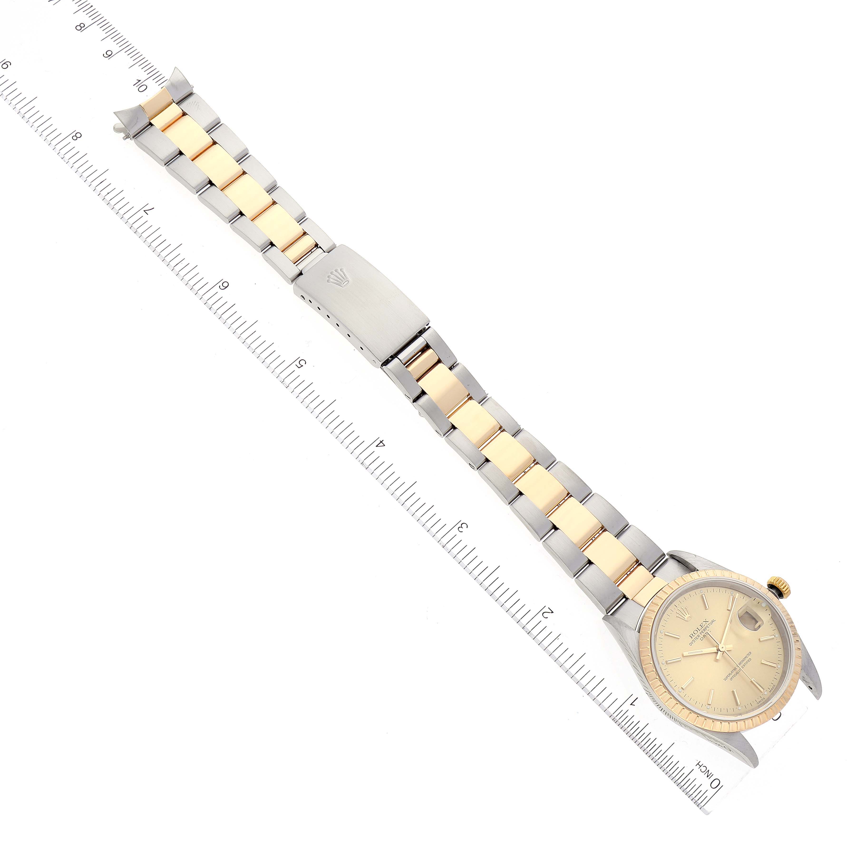 The image shows a Rolex Date 15223 Men's Steel and Gold (two tone) Champagne Dial 15223 Men's Steel and Gold (two tone) Champagne Dial model watch laid flat, displaying the full bracelet, clasp, and face with a ruler for scale.